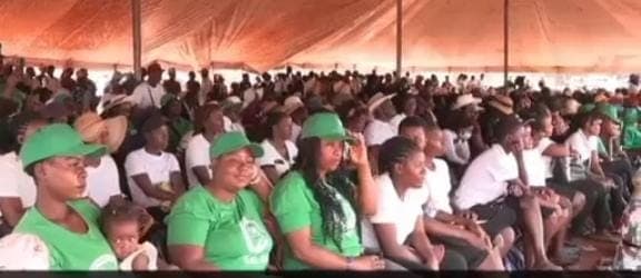 Large crowd under tent at welfare event